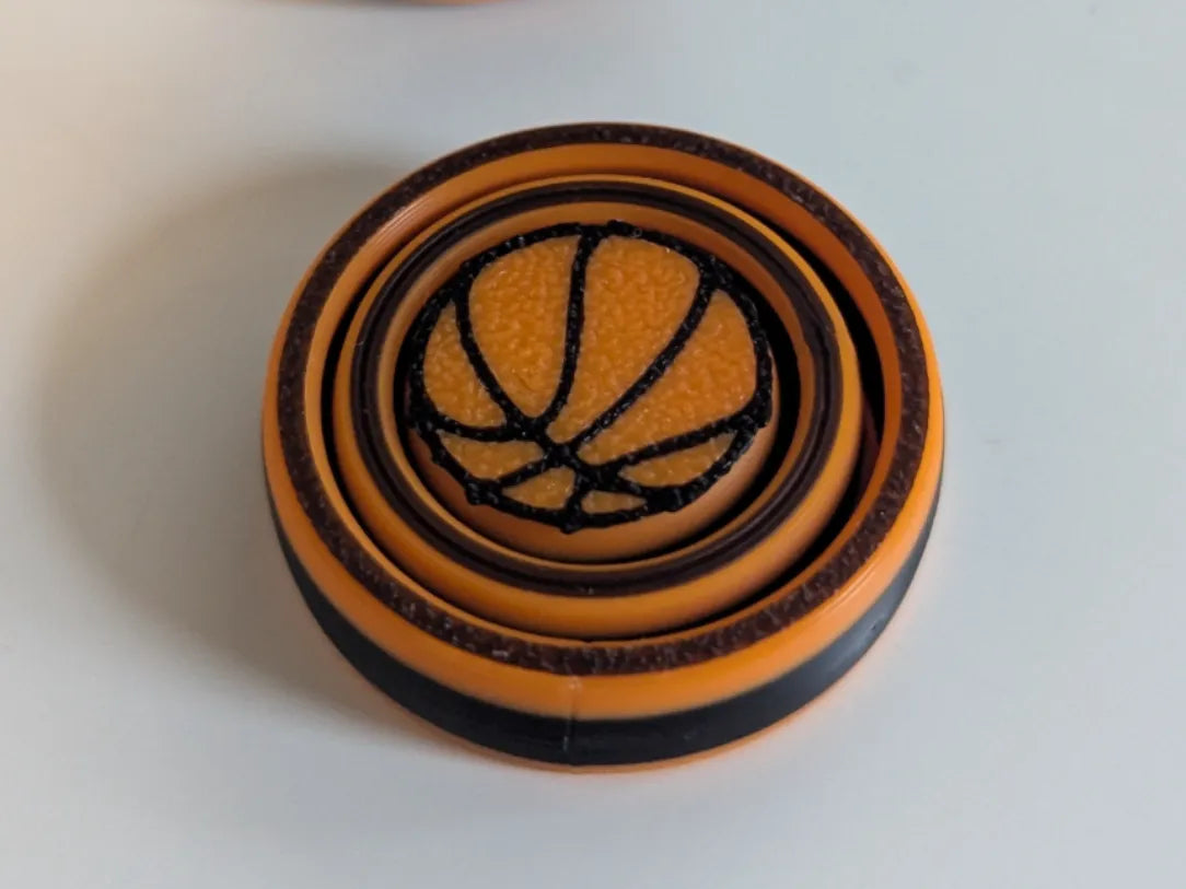 Toupie anti-stress basket-ball - 2 anneaux - Bijoux Print