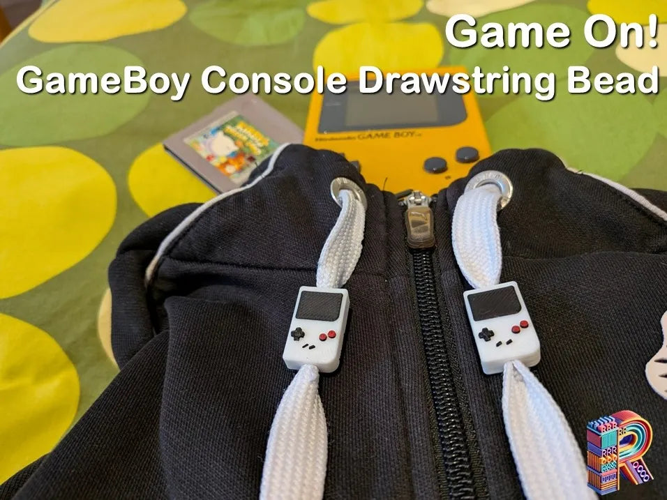 En route pour le jeu ! – Perle à cordon en forme de console Game Boy - Geek Print